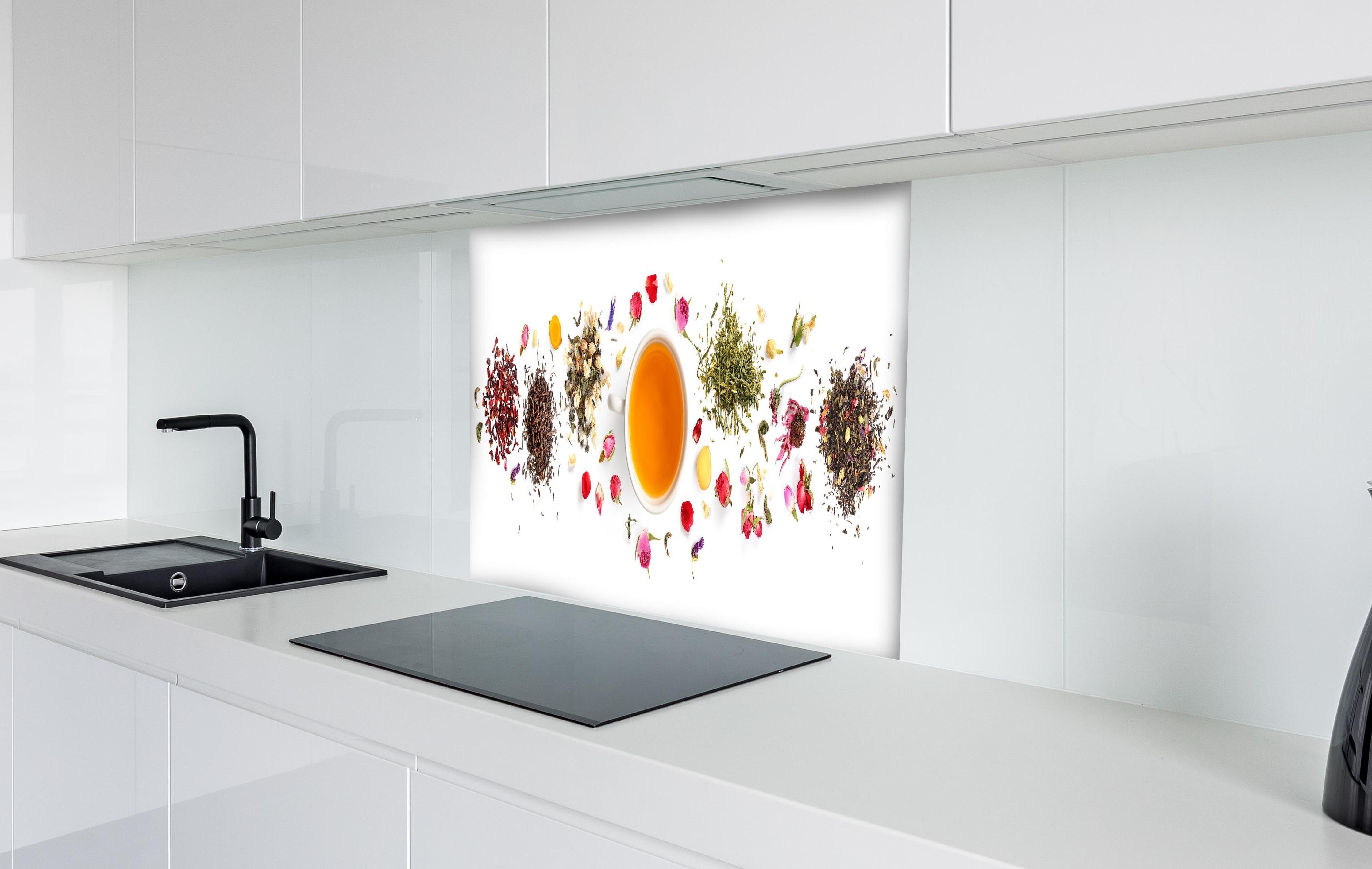 Spritzschutz - Exquisite Teesorten umgeben von Blumen hinter einem Cerankochfeld zwischen Holz-Kochutensilien
