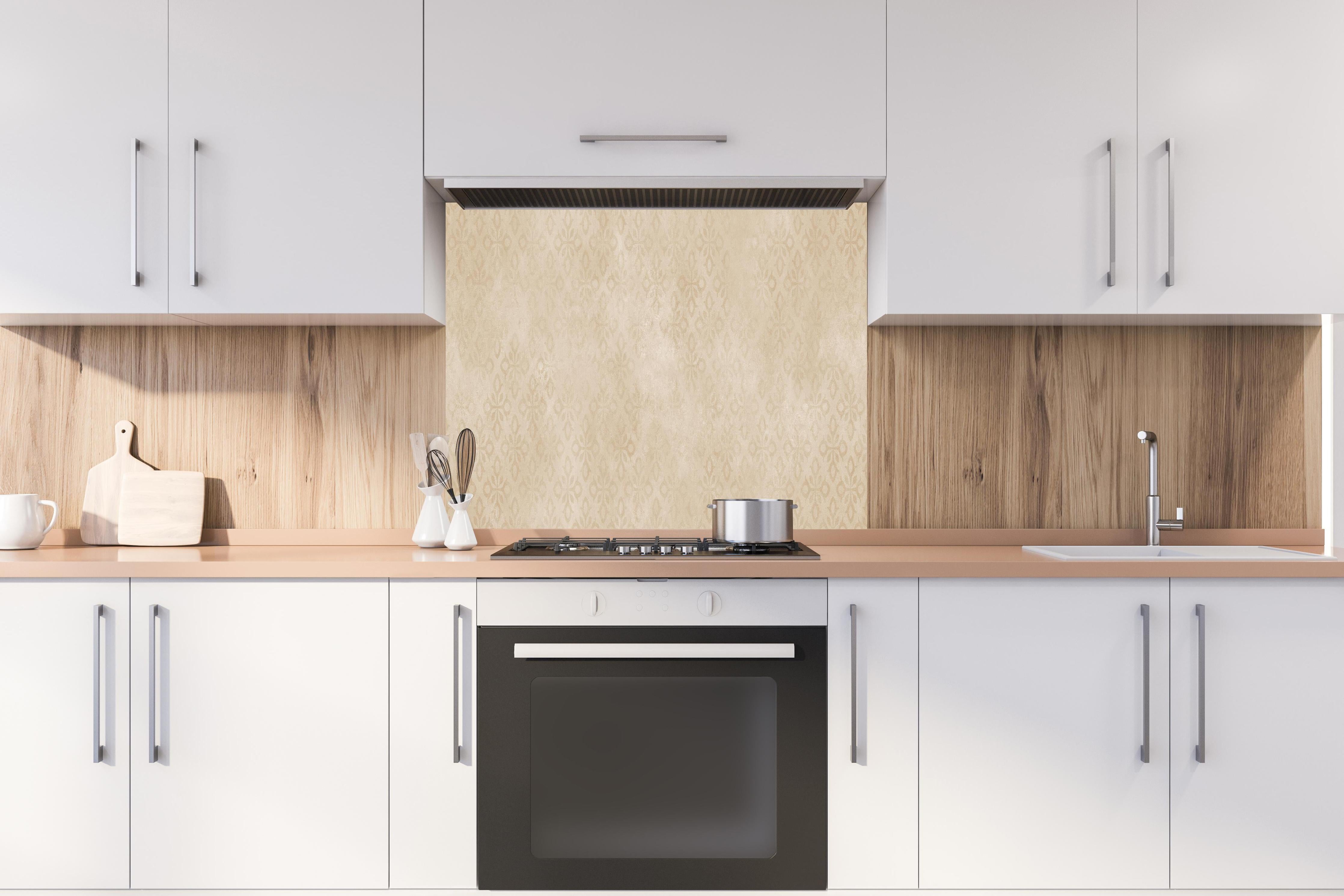 Spritzschutz - Feines Ornament Muster  hinter einem Cerankochfeld zwischen Holz-Kochutensilien
