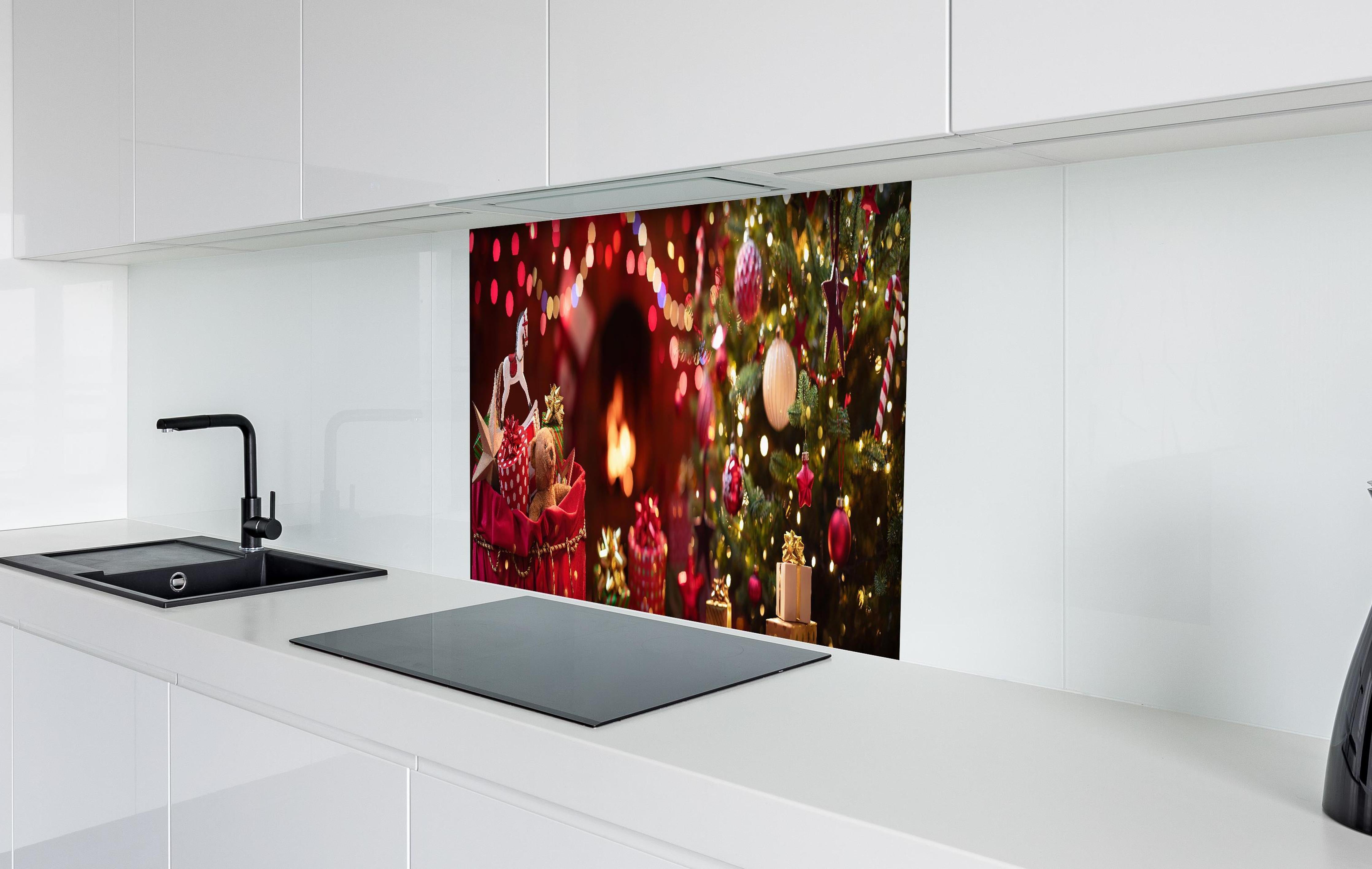 Spritzschutz - Festliche Weihnachtsdeko Rot-Gold Tannenbaum hinter einem Cerankochfeld zwischen Holz-Kochutensilien
