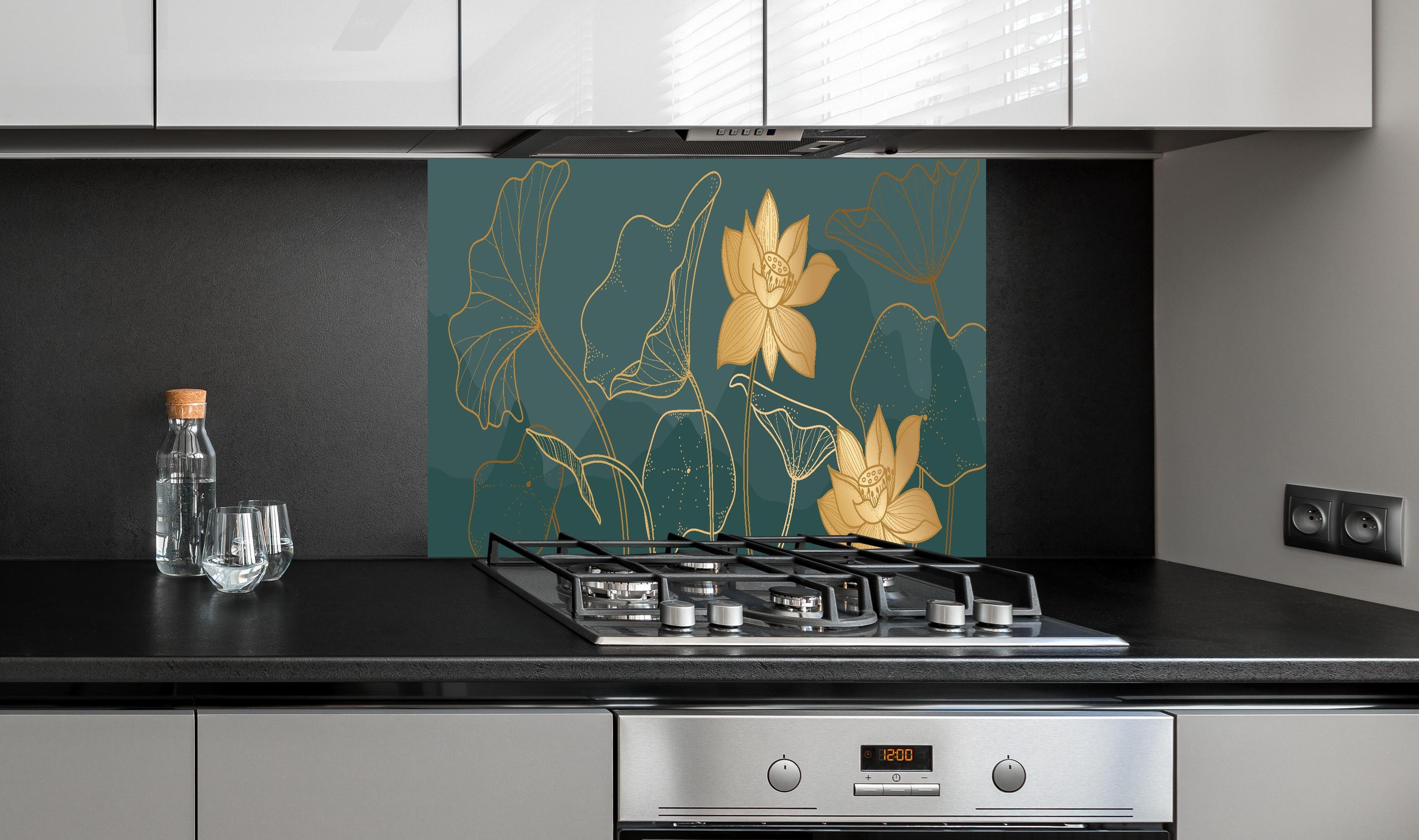 Spritzschutz - Gold Lotus Kunstwerk mit dunklem Hintergrund hinter einem Cerankochfeld zwischen Holz-Kochutensilien
