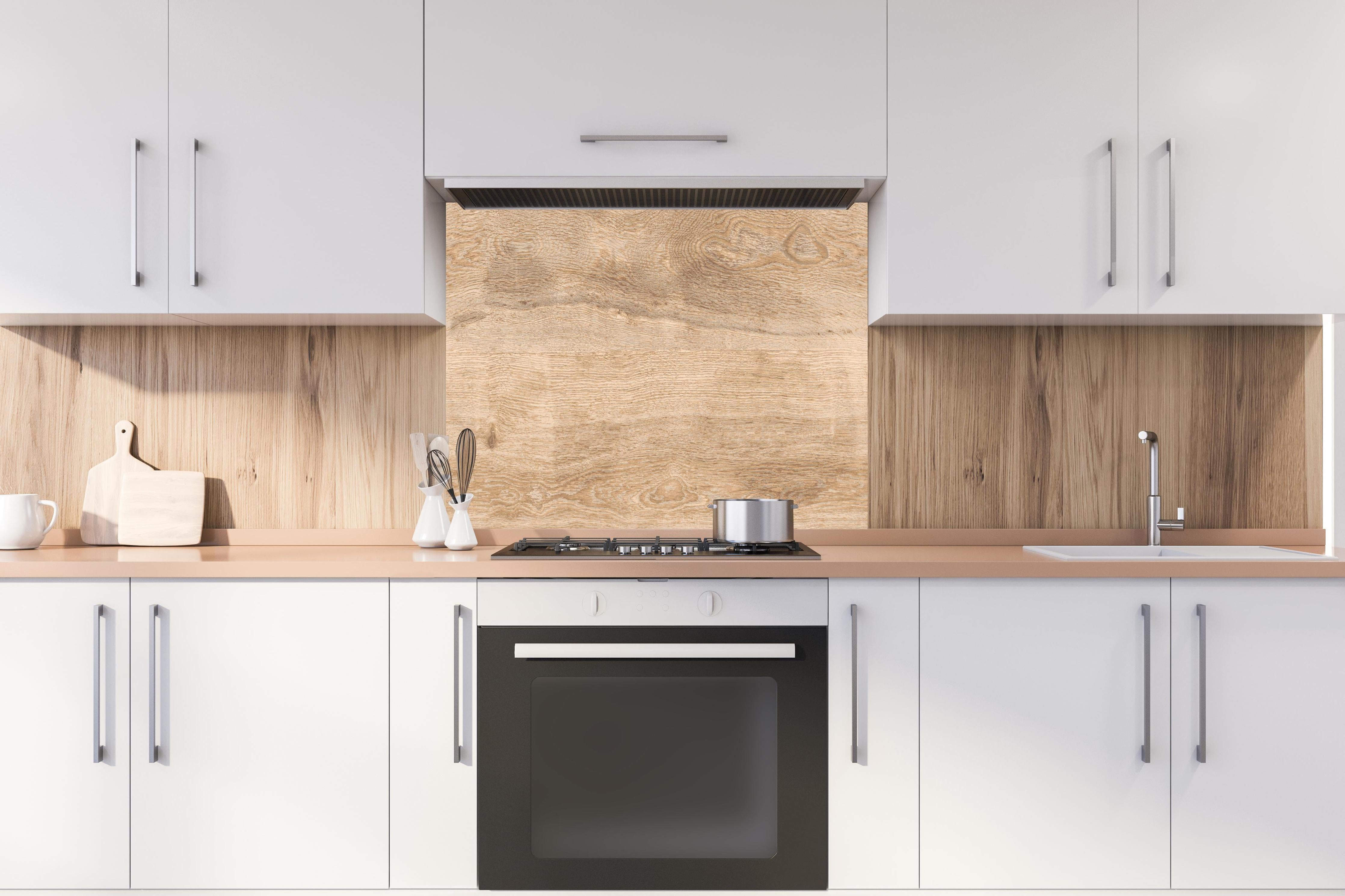 Spritzschutz - Hellbraunes Eichenholz hinter einem Cerankochfeld zwischen Holz-Kochutensilien
