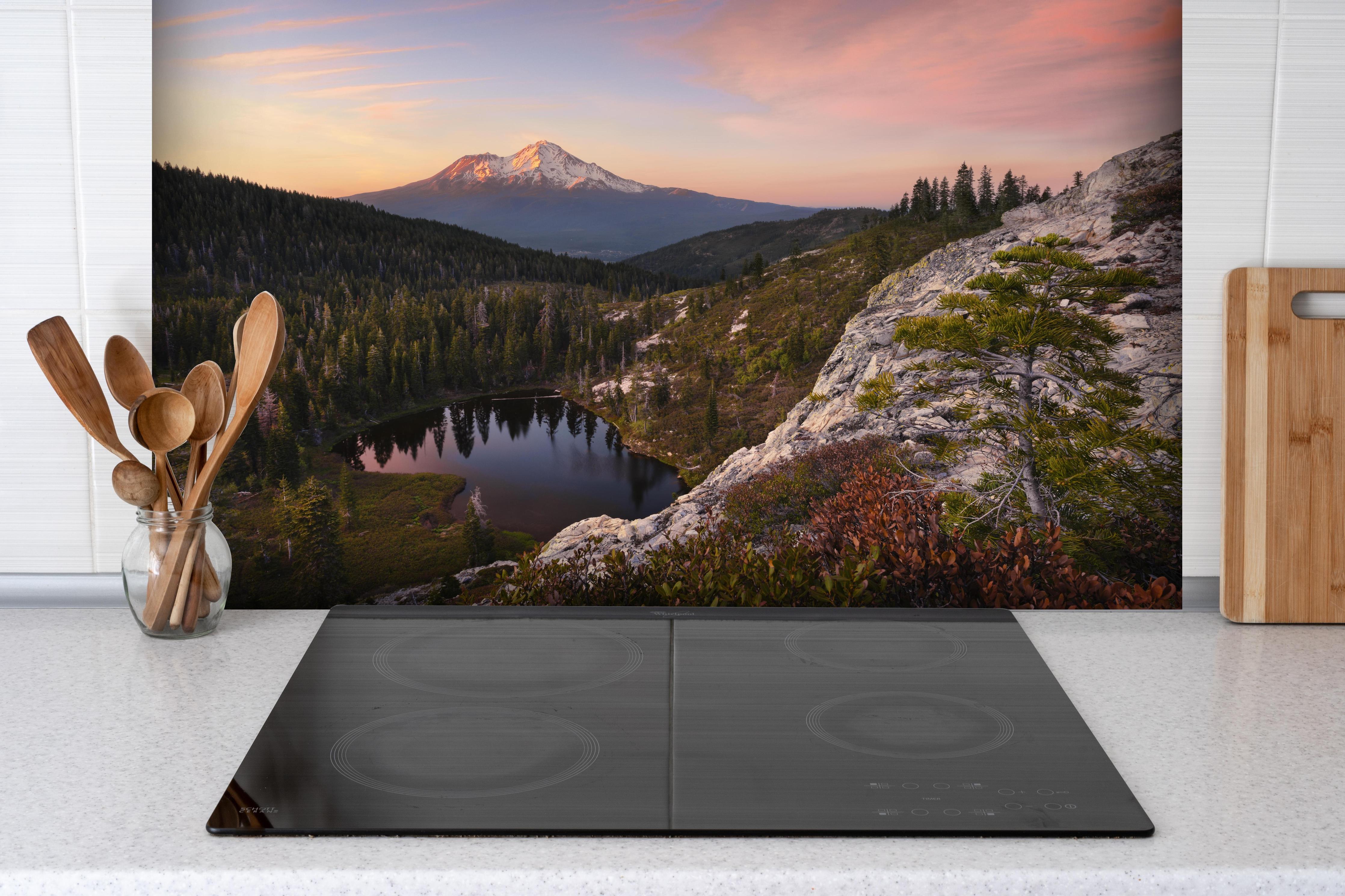 Spritzschutz - Idyllische Berglandschaft mit Herzsee hinter einem Cerankochfeld zwischen Holz-Kochutensilien
