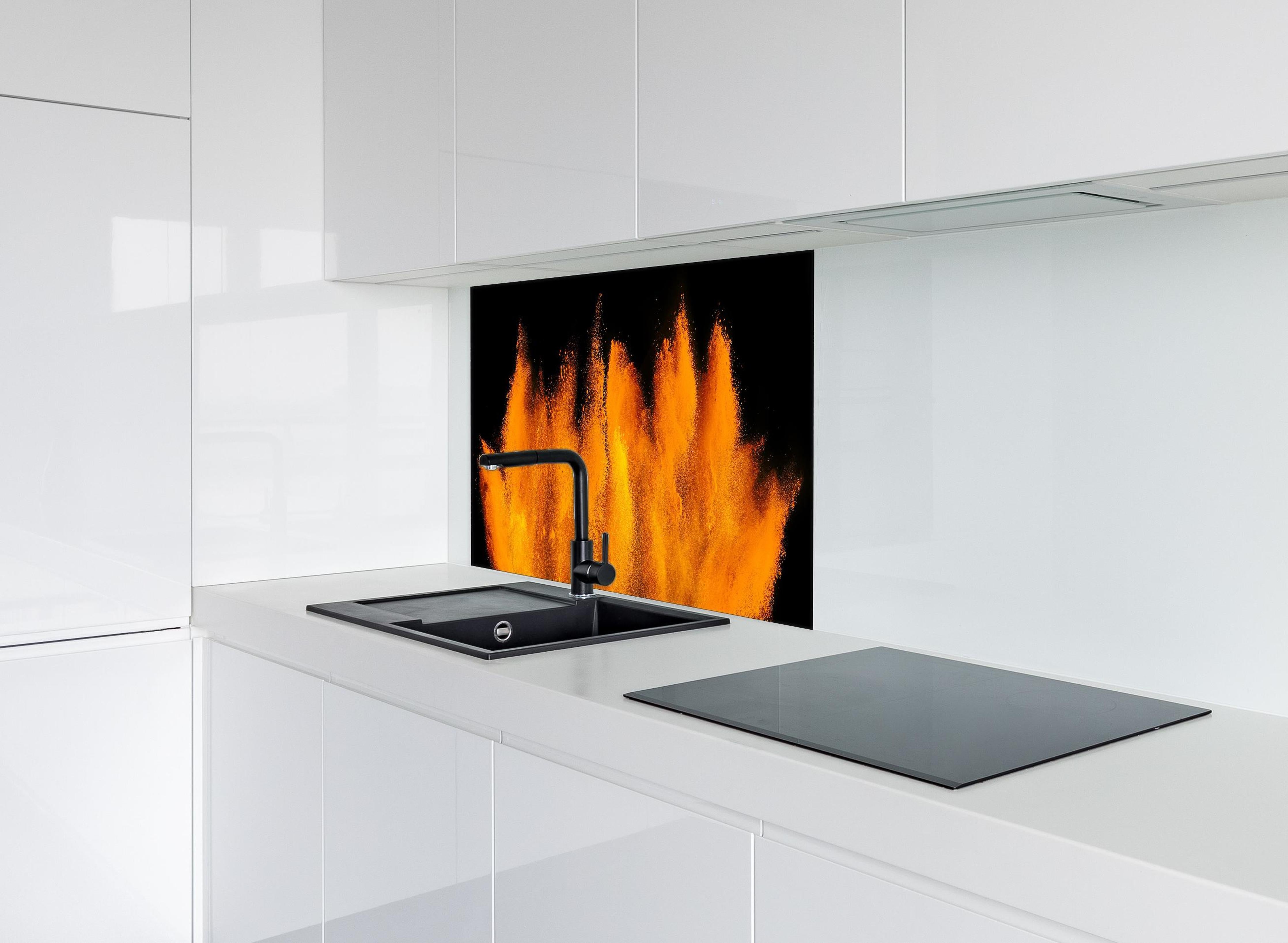 Spritzschutz - Lebendige Holi Farbexplosion auf Schwarz hinter einem Cerankochfeld zwischen Holz-Kochutensilien
