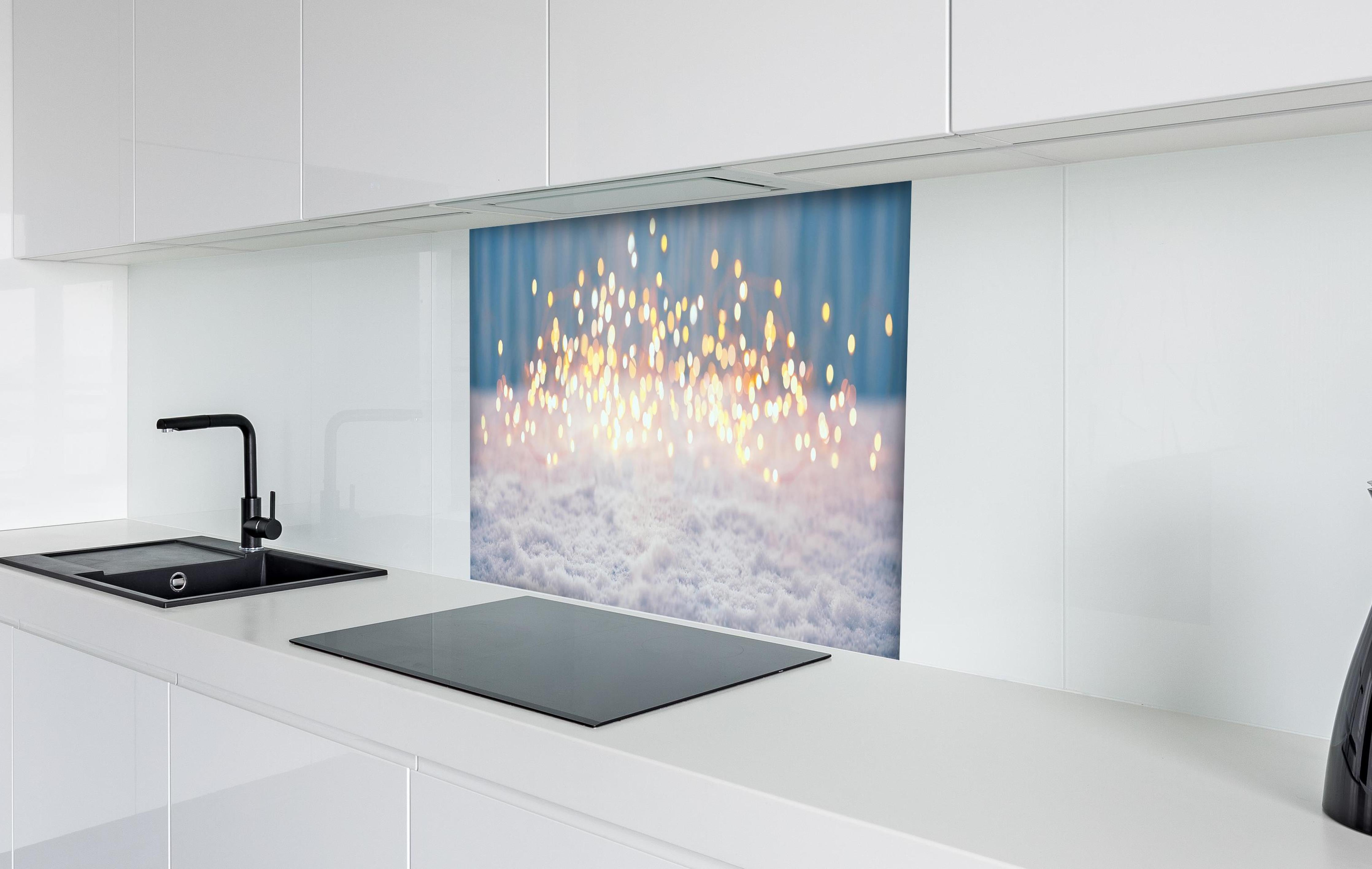 Spritzschutz - Magische Winterlandschaft mit goldenem Bokeh hinter einem Cerankochfeld zwischen Holz-Kochutensilien
