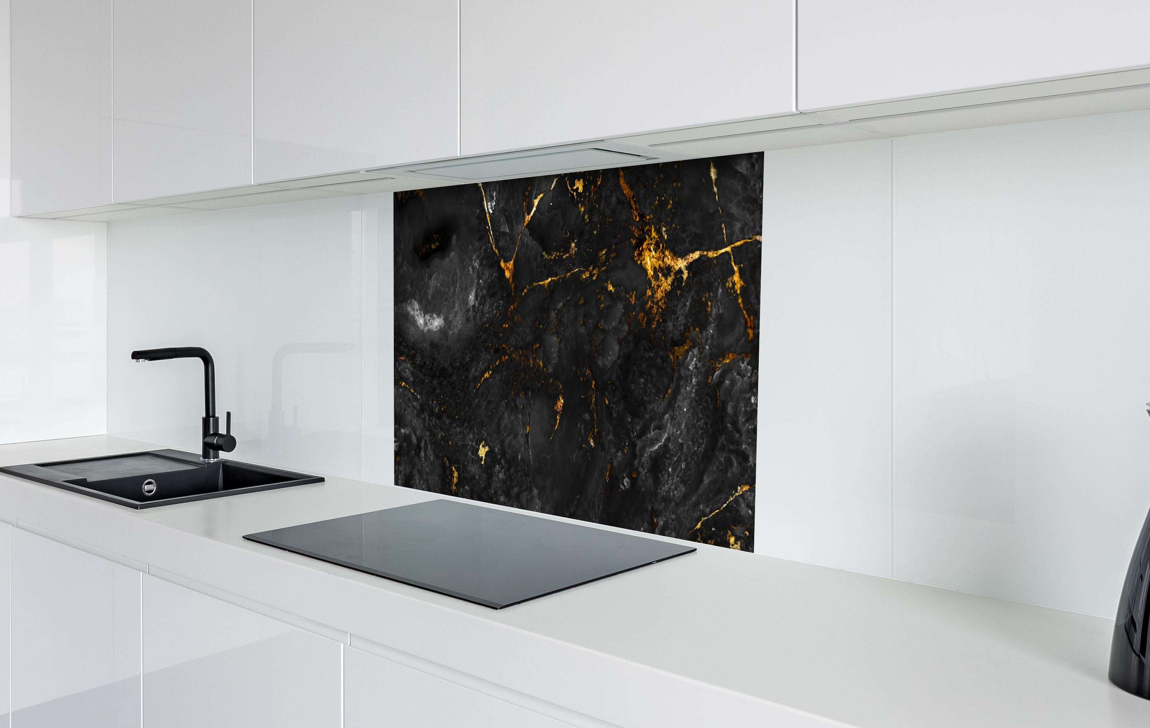 Spritzschutz - Natürliche schwarze Marmorstruktur mit goldenen Adern hinter einem Cerankochfeld zwischen Holz-Kochutensilien
