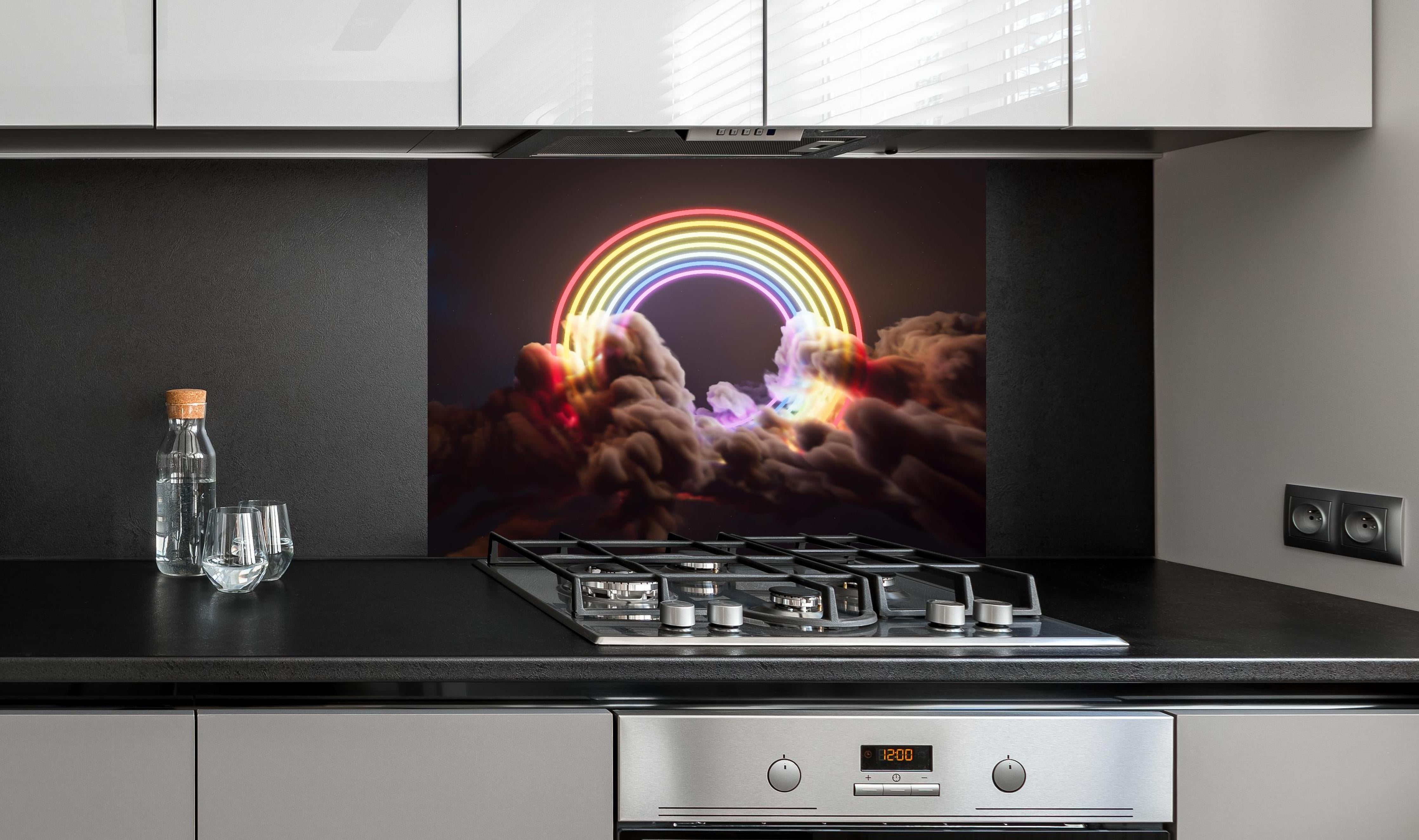 Spritzschutz - Neon-Leuchtender Regenbogen zwischen Wolken hinter einem Cerankochfeld zwischen Holz-Kochutensilien
