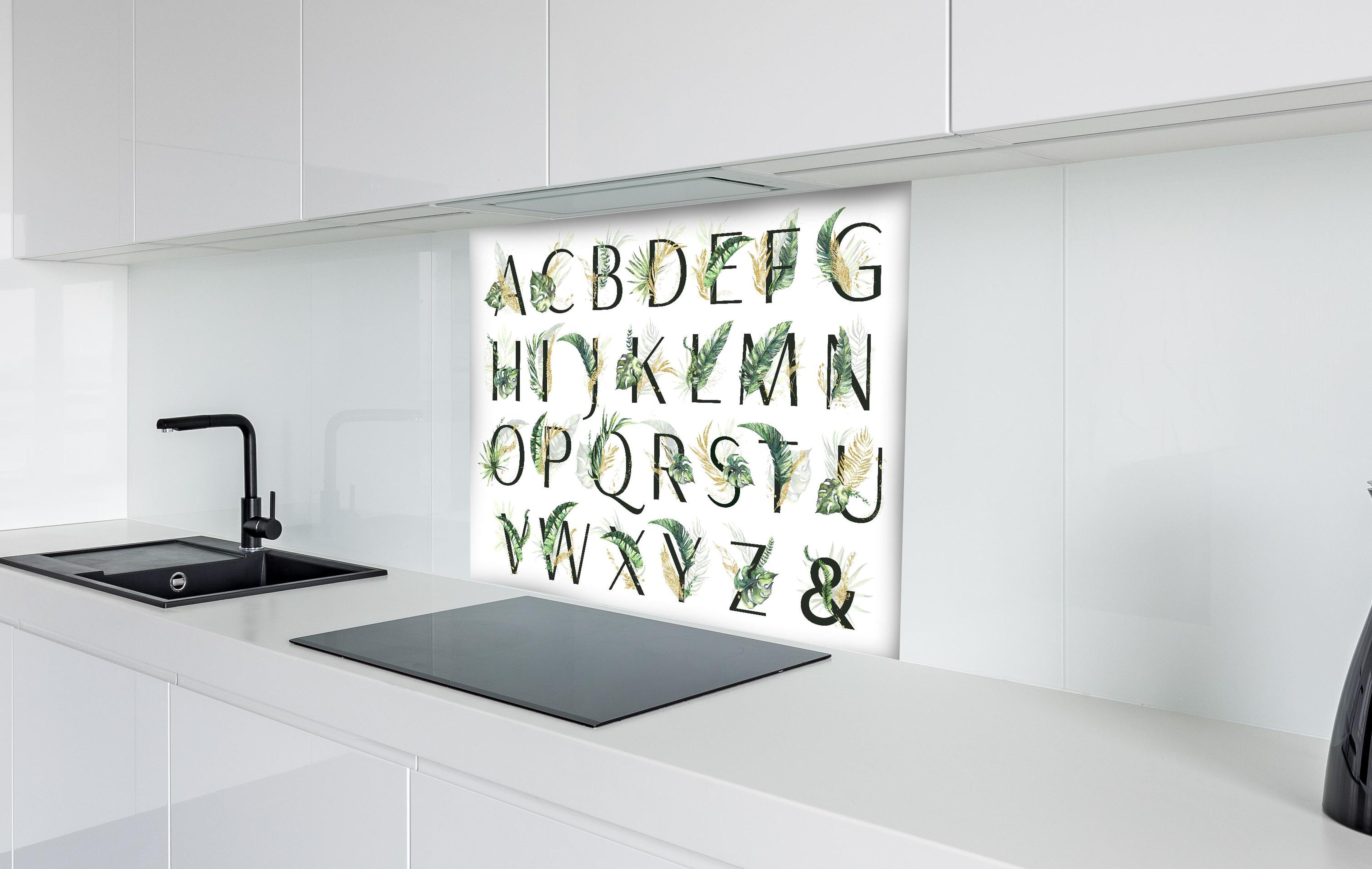 Spritzschutz - Pflanzliche Alphabet Sammlung hinter einem Cerankochfeld zwischen Holz-Kochutensilien
