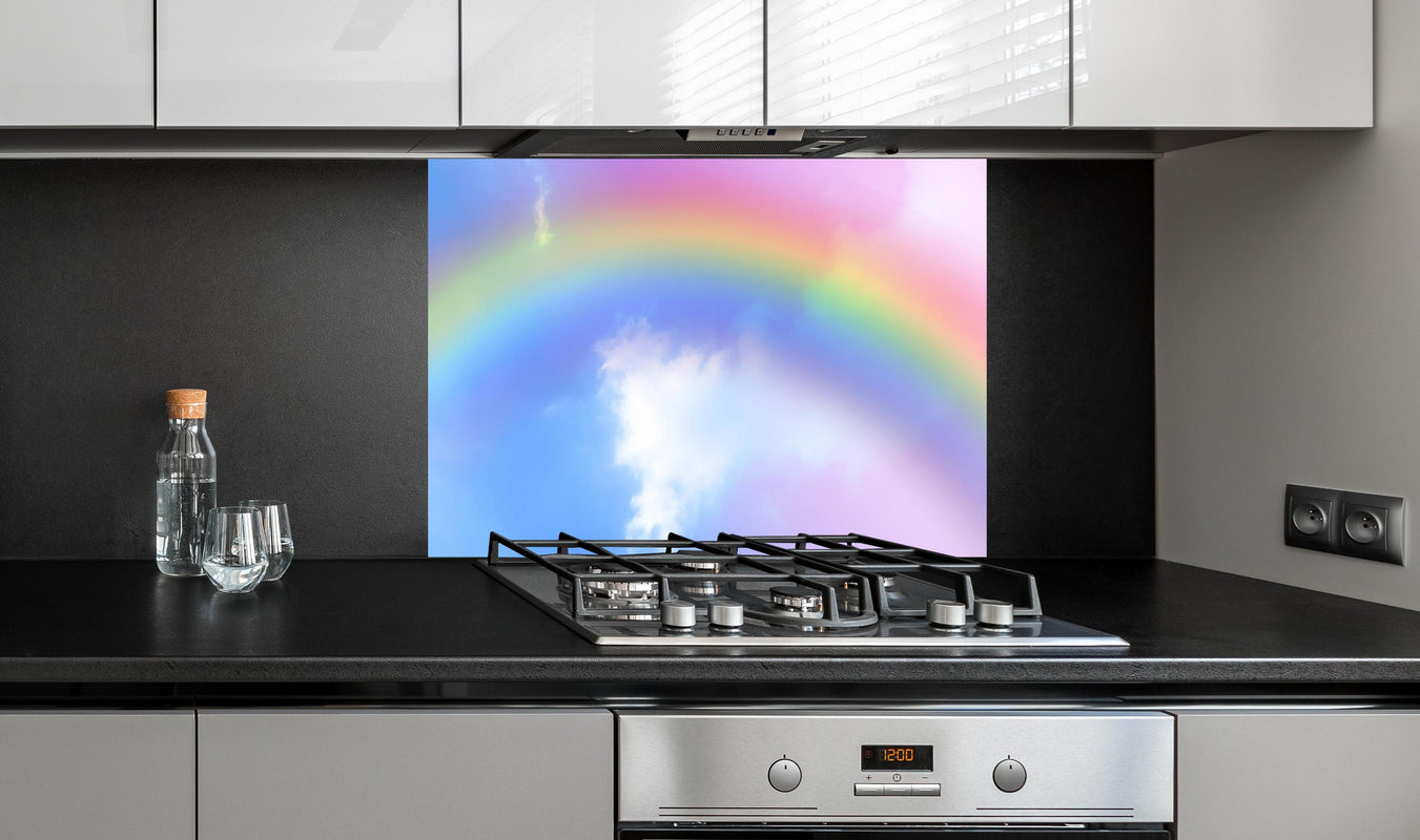 Spritzschutz - Regenbogen im Wolkenhimmel hinter einem Cerankochfeld zwischen Holz-Kochutensilien
