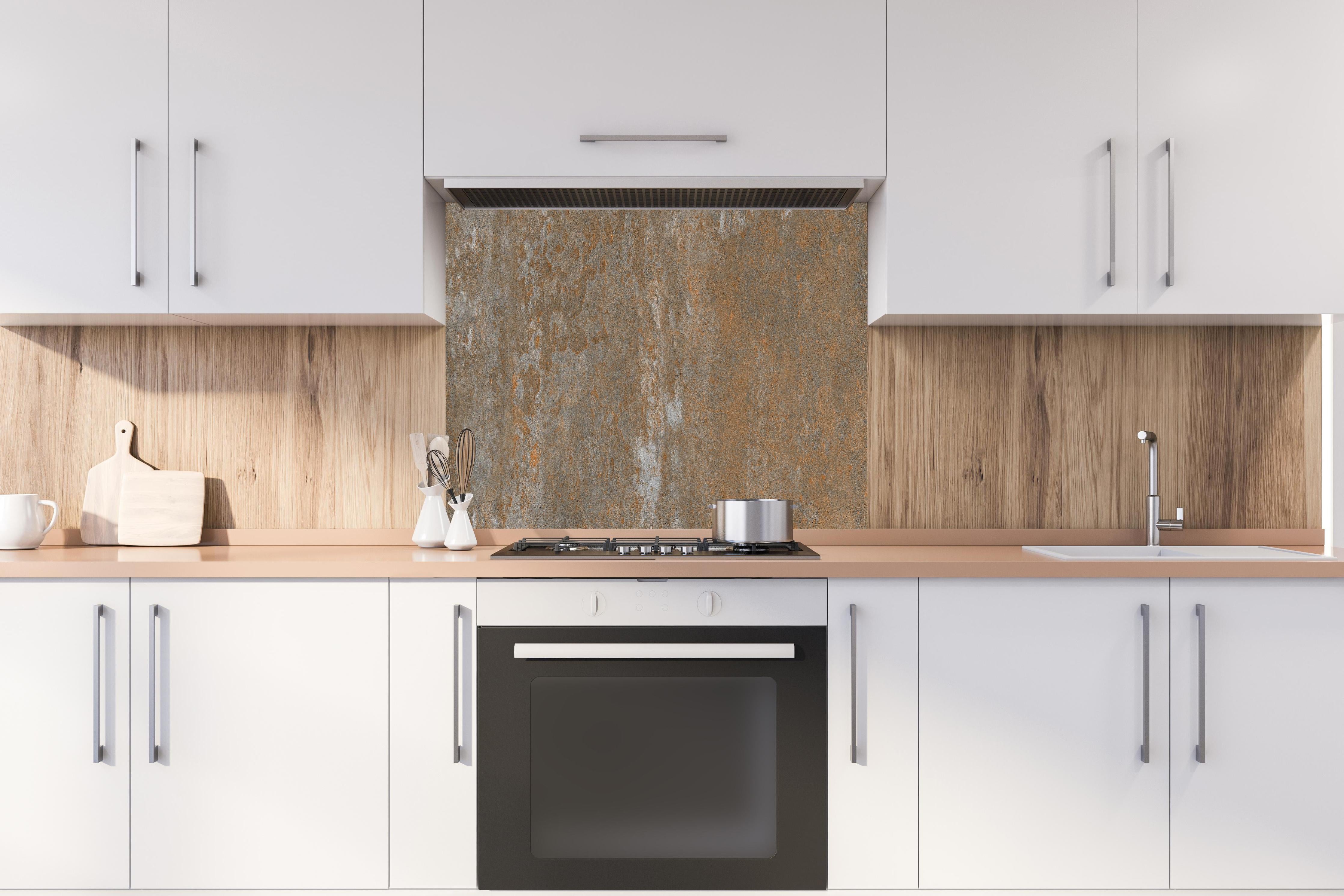 Spritzschutz - Rustikaler Stein Hintergrund hinter einem Cerankochfeld zwischen Holz-Kochutensilien
