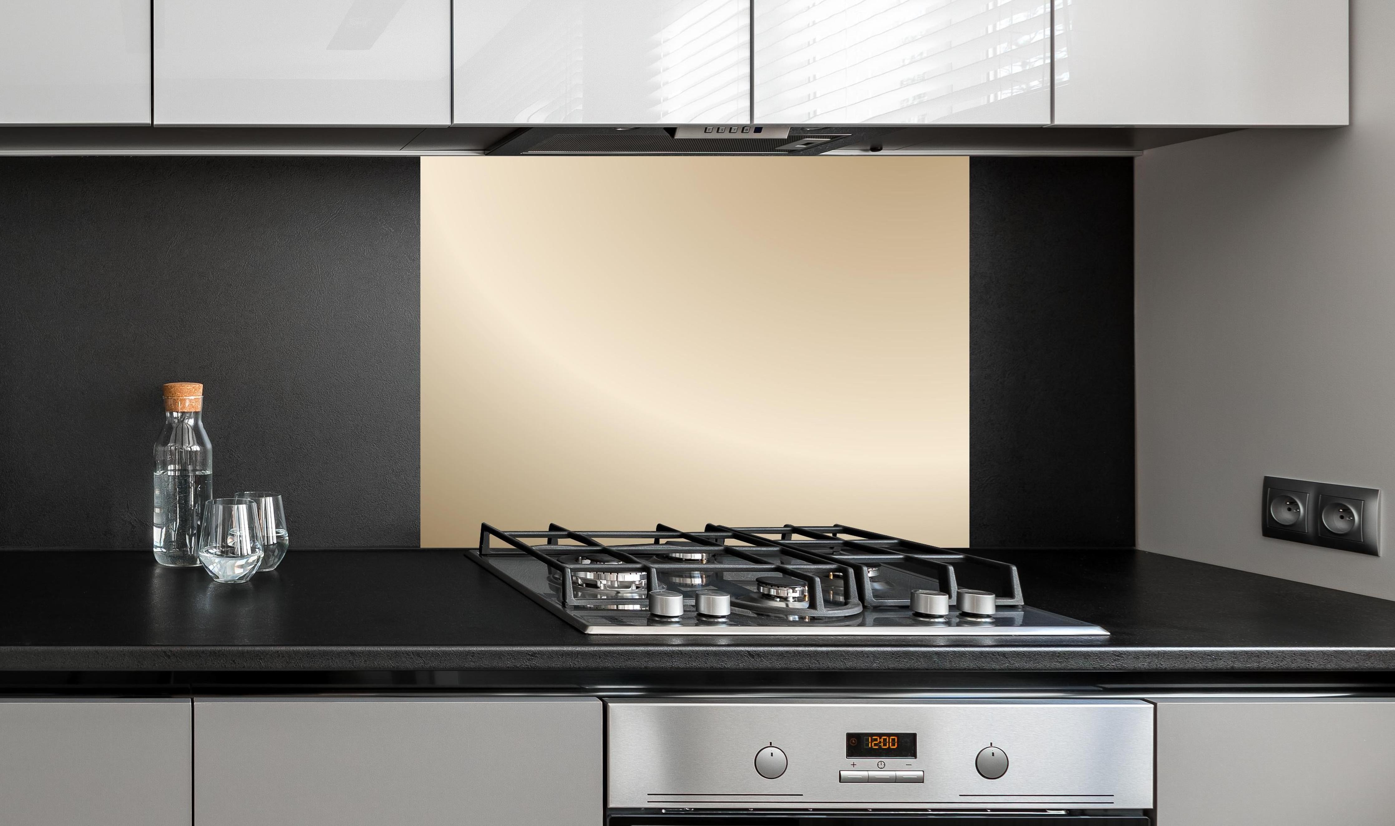 Spritzschutz - Sanfter Beige-Creme Farbverlauf Hintergrund hinter einem Cerankochfeld zwischen Holz-Kochutensilien
