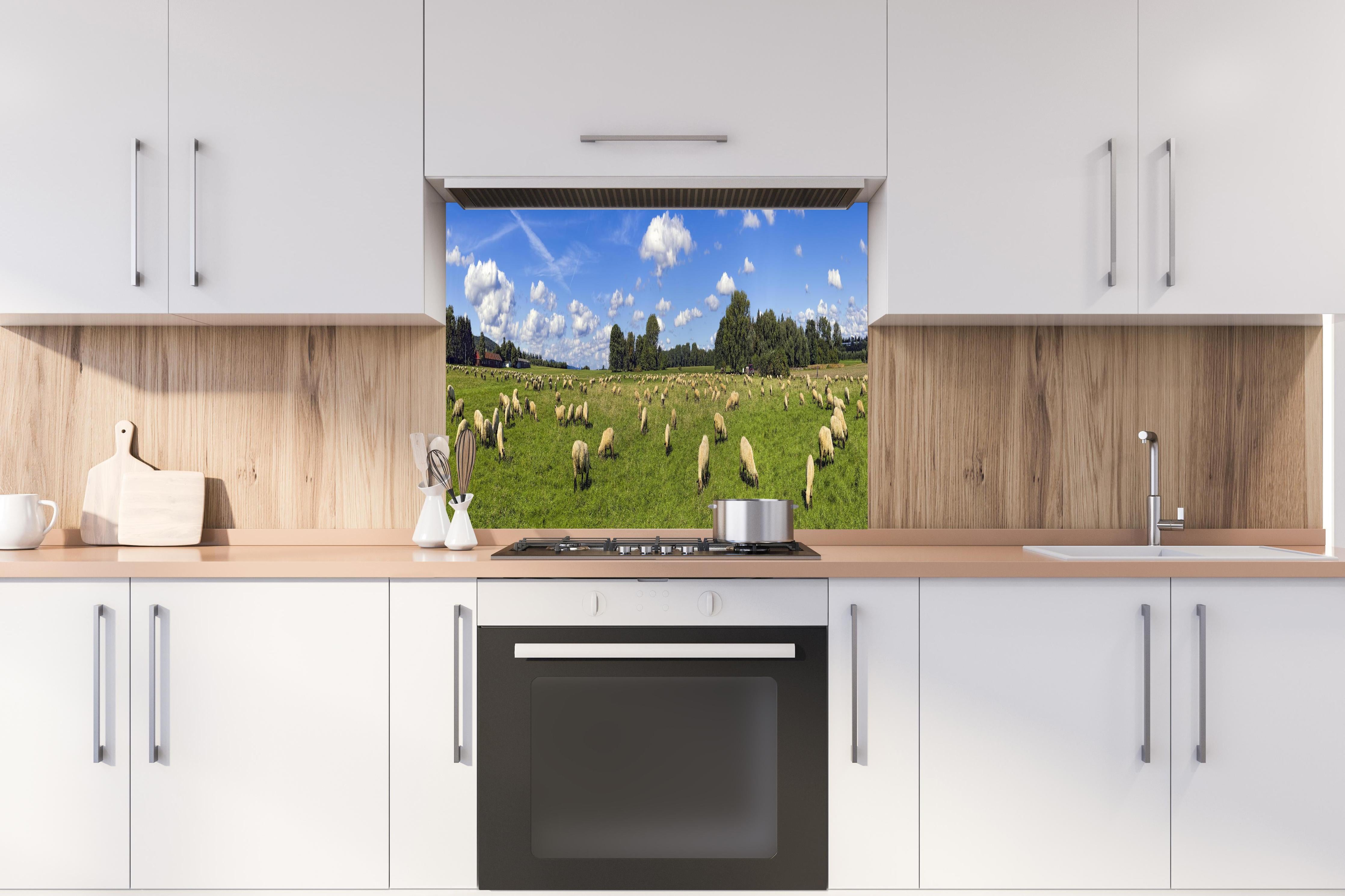 Spritzschutz - Schafherde Panorama hinter einem Cerankochfeld zwischen Holz-Kochutensilien
