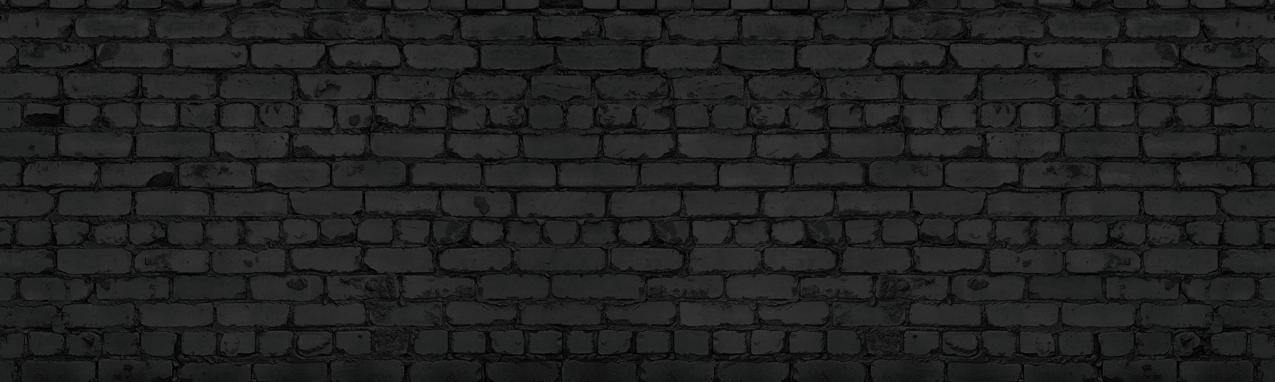 Spritzschutz-Schwarze raue Backsteinmauer