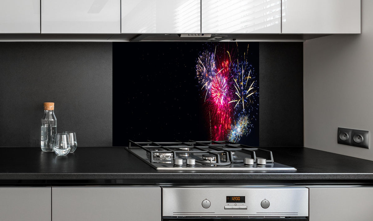 Spritzschutz - Spektakuläres Silvester Feuerwerk Erlebnis hinter einem Cerankochfeld zwischen Holz-Kochutensilien
