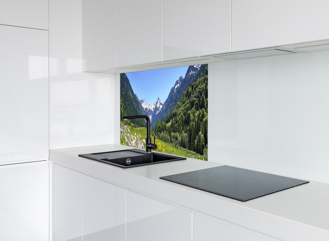 Spritzschutz - Bunte Wiese in den Alpen hinter modernem schwarz-matten Spülbecken in weißer Hochglanz-Küche