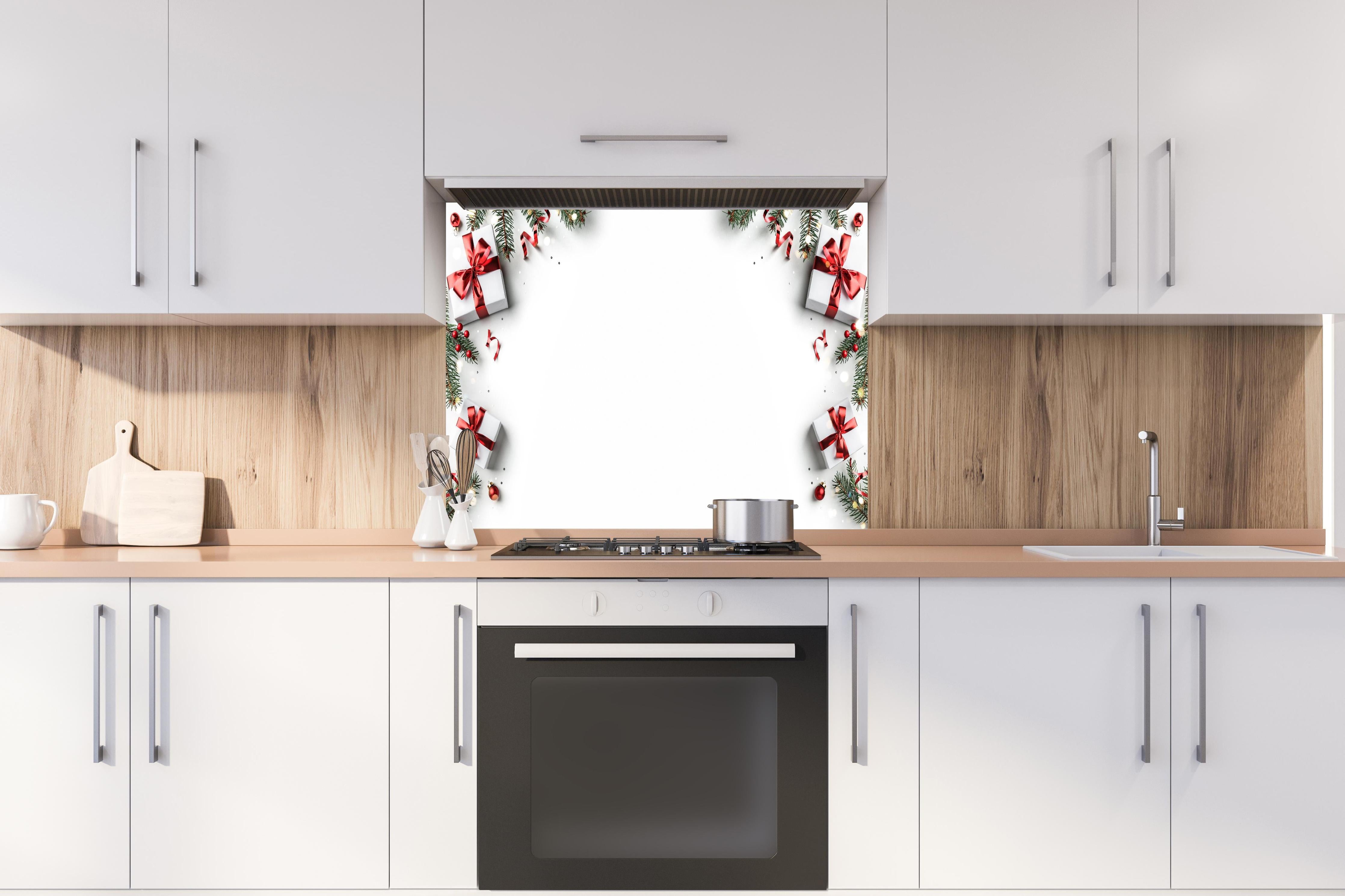 Spritzschutz - Tannenzweige als Rahmen hinter einem Cerankochfeld zwischen Holz-Kochutensilien
