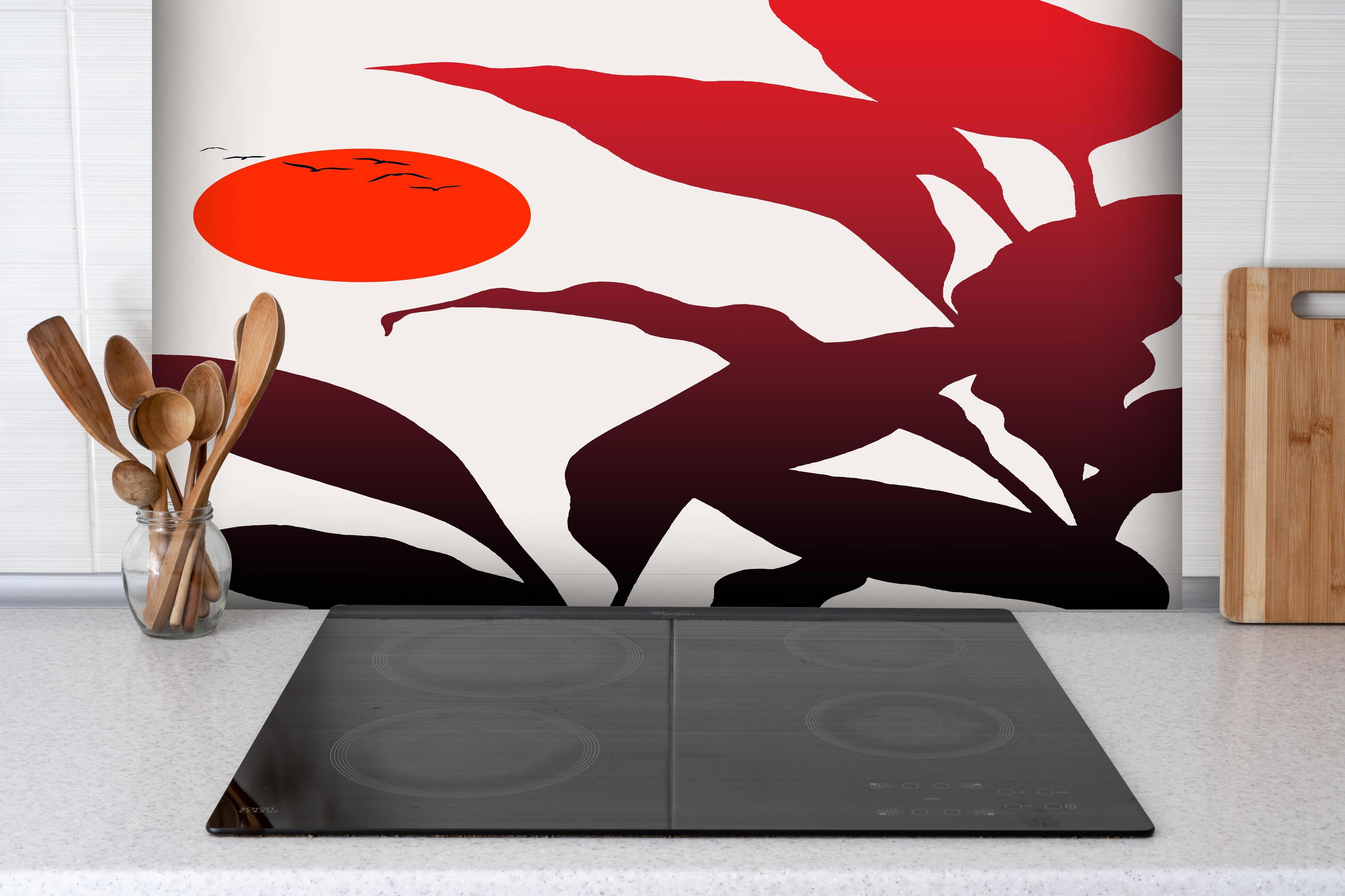 Spritzschutz - Tropischer Sonnenuntergang  hinter einem Cerankochfeld zwischen Holz-Kochutensilien
