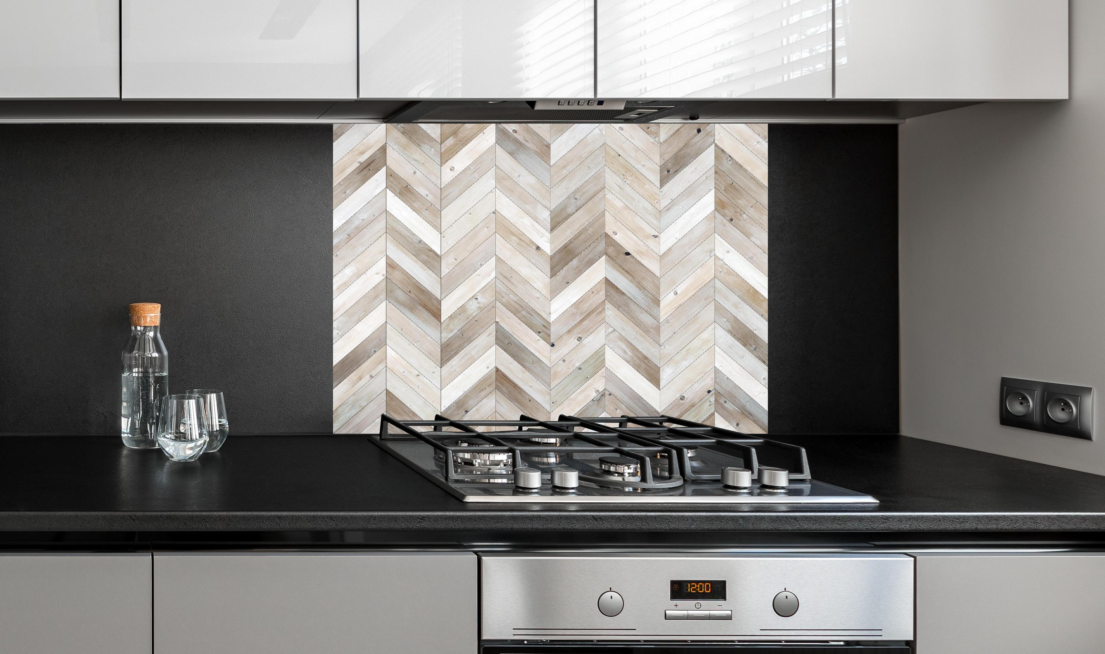 Spritzschutz - Weiße Chevron Textur hinter einem Cerankochfeld zwischen Holz-Kochutensilien
