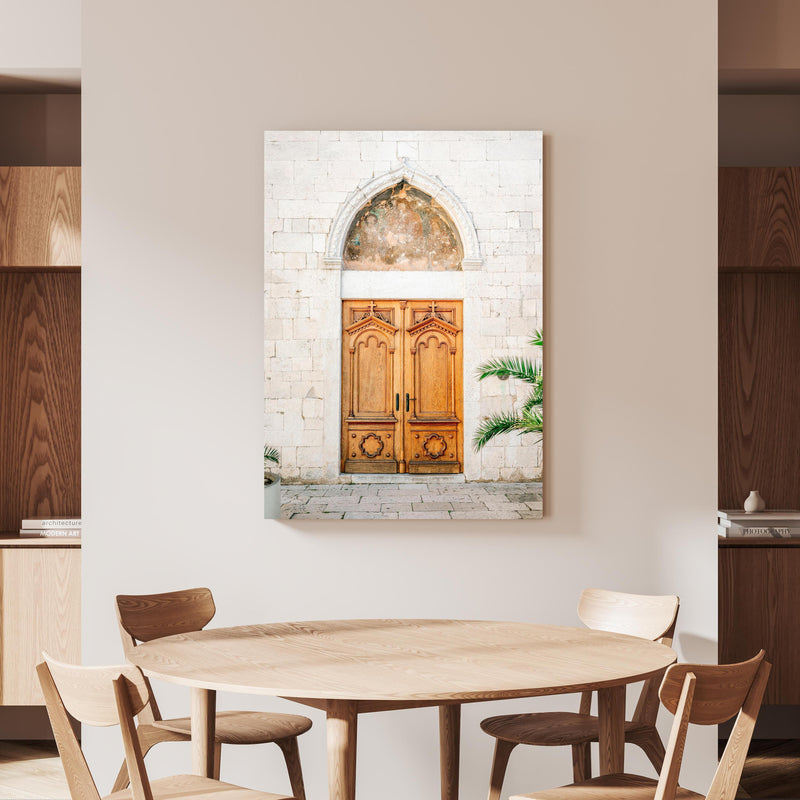 Wandbild - Croatian Door an beiger Wand hinter handgeschnitztem Holztisch 