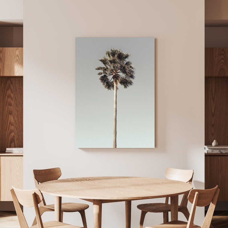 Wandbild - Einfache Palme  an beiger Wand hinter handgeschnitztem Holztisch 