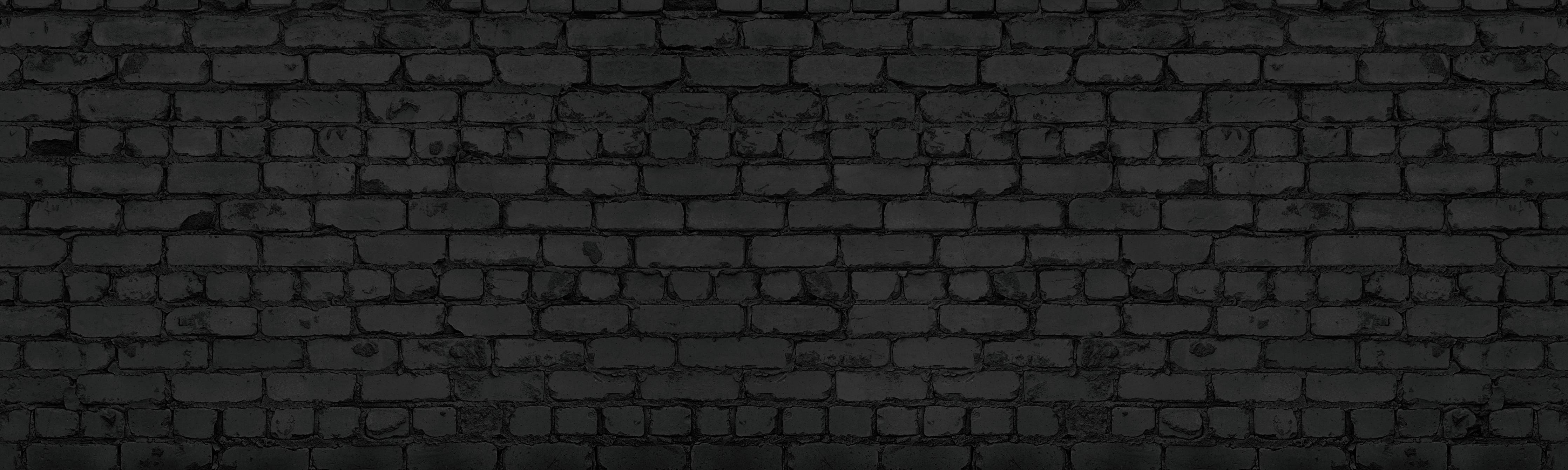 Wandverkleidung Wohnzimmer-Schwarze raue Backsteinmauer